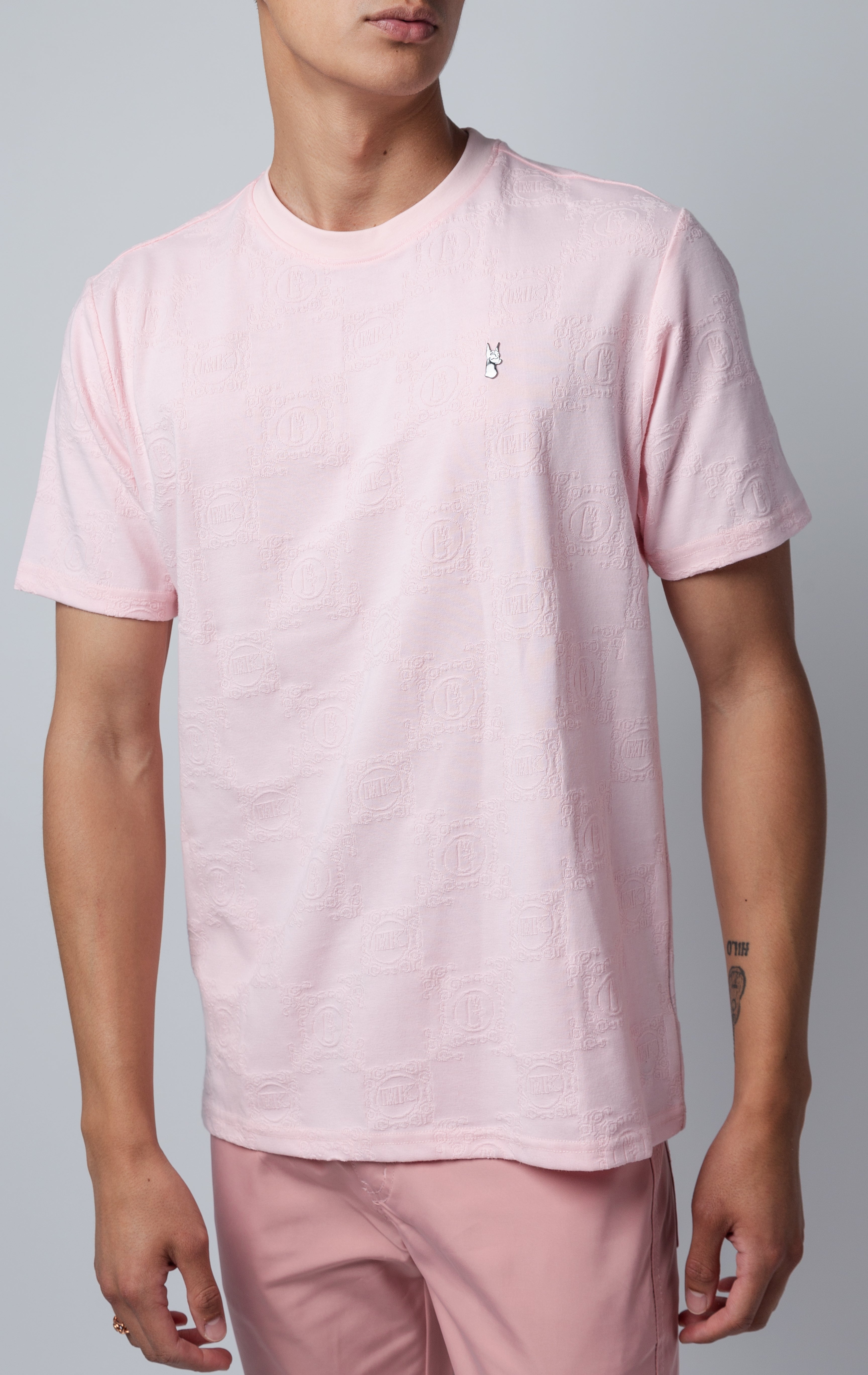 pink all-over tonal embossed pattern, short sleeve t-shirt with logo hardware on left side of chest