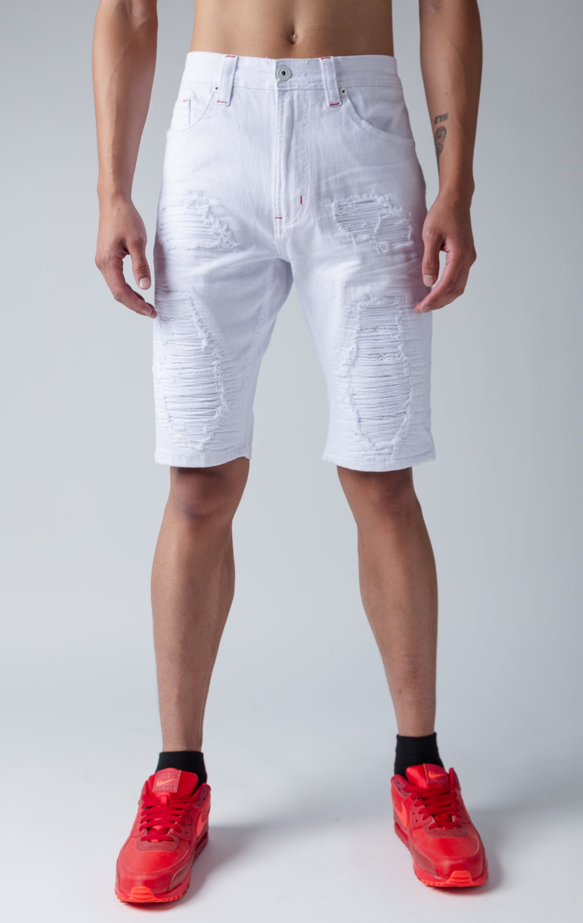 White denim shredded shorts with fused shreds, crinkle effect through out