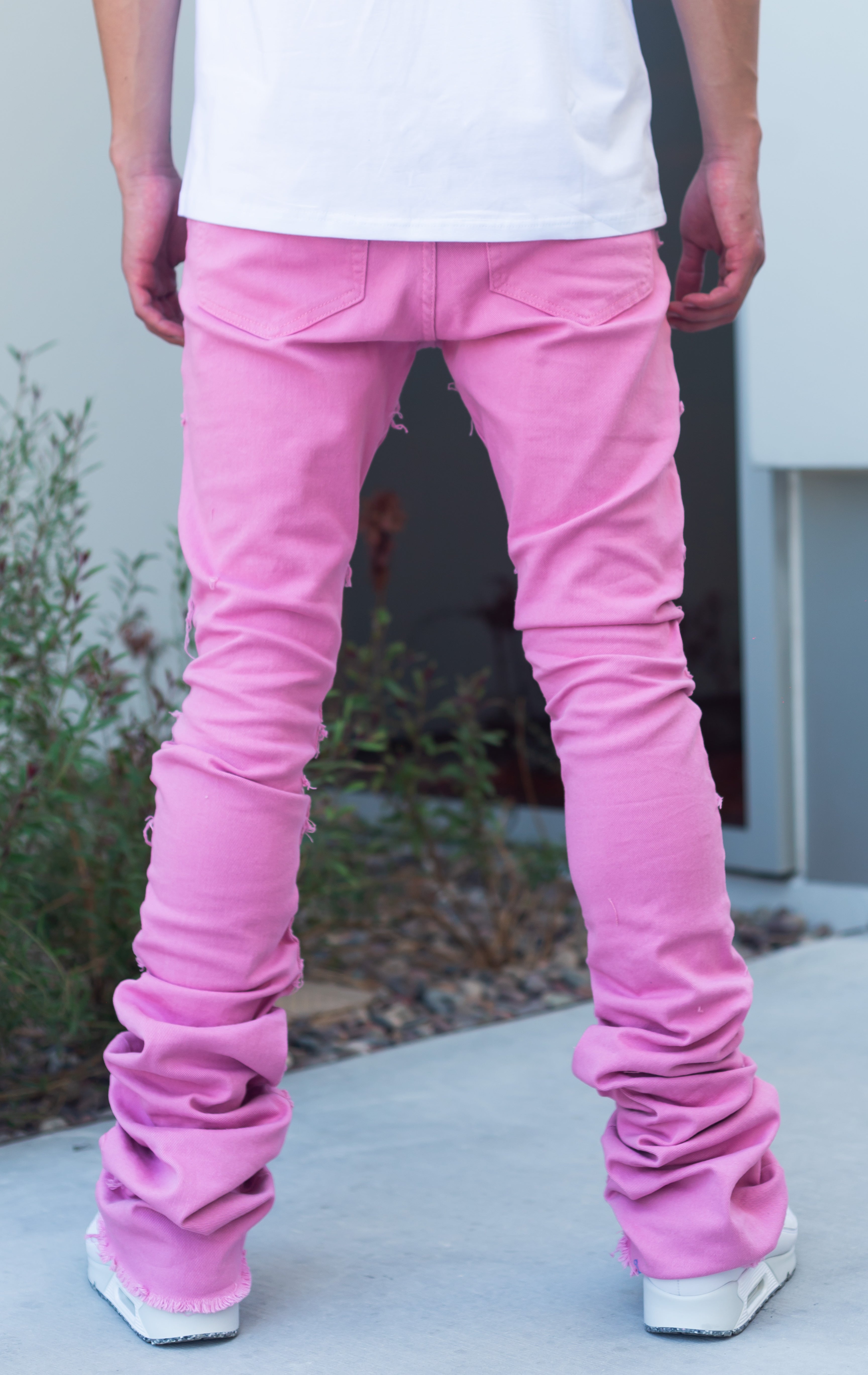 Pink super stacked denim. Featuring 7-pocket design, button utility pockets, exposed stitching, frayed hems, super stacked construction, flare leg openings, and impressive 46.5" seams.