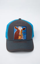 Black and blue trucker hat with cow giant graphic