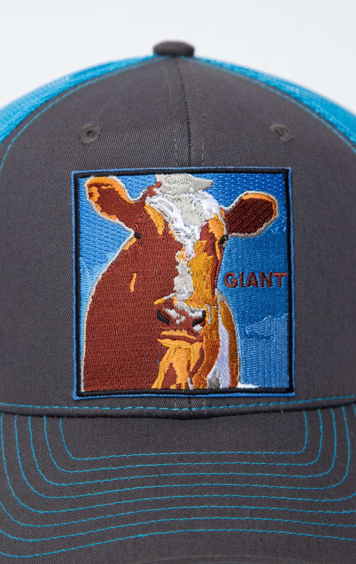 Black and blue trucker hat with cow giant graphic