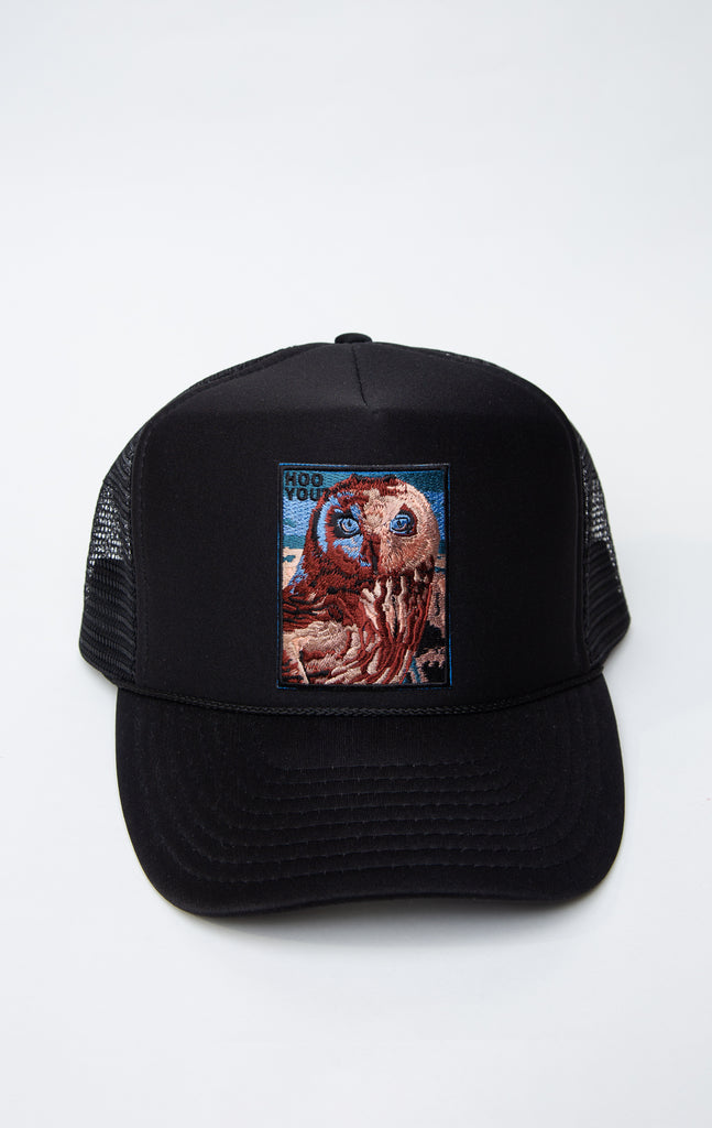 black trucker hat with owl graphic