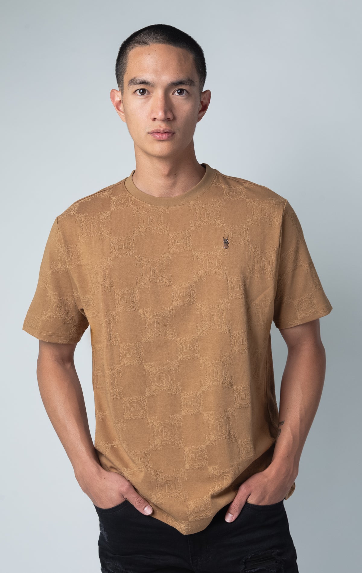 mocha all-over tonal embossed pattern, short sleeve t-shirt with logo hardware on left side of chest