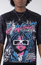 Washed black/purple oversized t-shirt featuring a large graphic of a figure with blue dreadlocks and white 3D glasses. The graphic includes the text "G-WEST Studios" and "THE BEST PREPARATION FOR TOMORROW IS DOING YOUR BEST TODAY!" accented with rhineston
