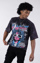 Person wearing a graphic t-shirt with colorful design on a white background