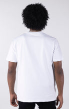 Person wearing a plain white t-shirt on a white background