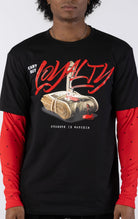 Black short-sleeve t-shirt with a red long-sleeve underneath, featuring a graphic of a stack of money stabbed by a knife and red blood. The word "LOYALTY" is printed in large red script, with "CANT BUY" and "STREETZ IZ WATCHIN" completing the design.
