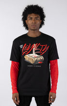 Black short-sleeve t-shirt with a red long-sleeve underneath, featuring a graphic of a stack of money stabbed by a knife and red blood. The word "LOYALTY" is printed in large red script, with "CANT BUY" and "STREETZ IZ WATCHIN" completing the design.