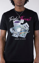 Black t-shirt with a detailed graphic featuring a pile of $100 bills, two dice, and a white cup with purple liquid. The text "Triple Threat" is printed above the image in white and pink script.