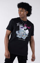 Black t-shirt with a detailed graphic featuring a pile of $100 bills, two dice, and a white cup with purple liquid. The text "Triple Threat" is printed above the image in white and pink script.