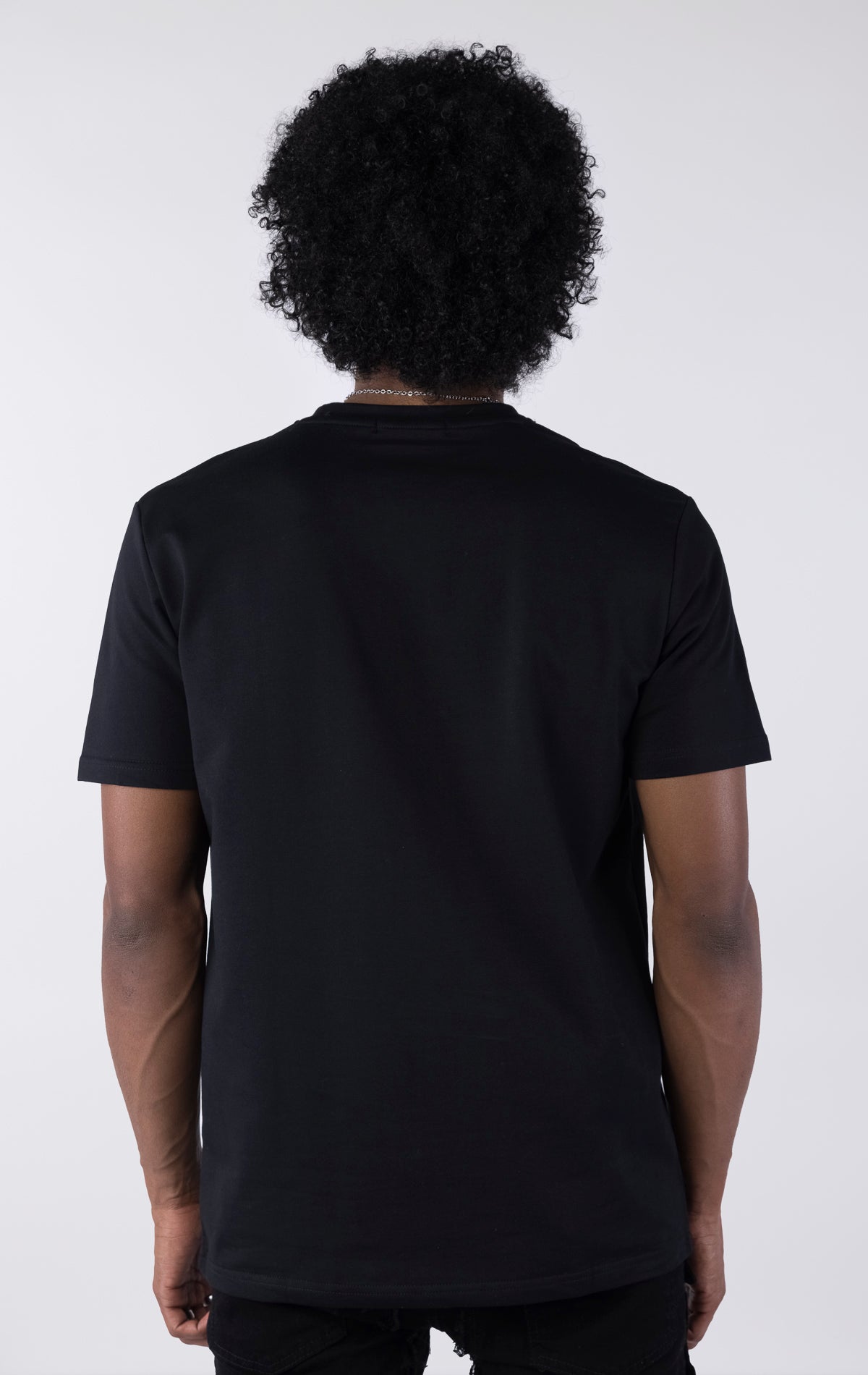 Person wearing a black t-shirt against a white background