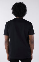 Person wearing a black t-shirt against a white background