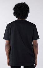 Person wearing a black t-shirt against a white background