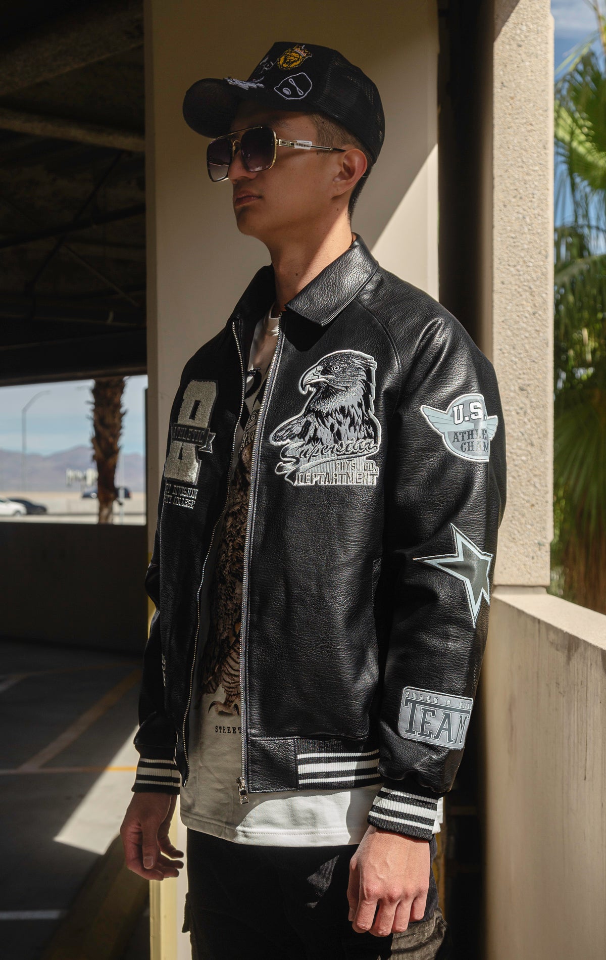 Black U.S.A. Varsity Jacket with patches, zip-up front, and quilted lining