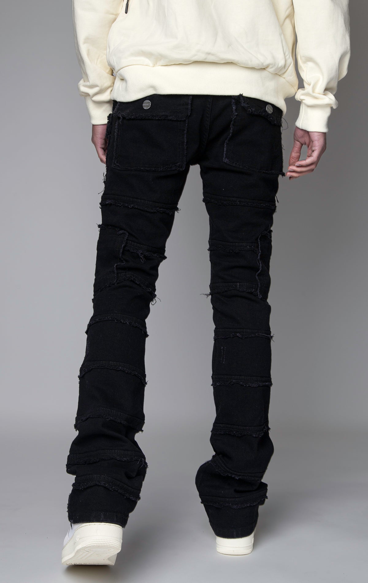 ice blue Stacked denim pants, distressed and paneled with a raw finishing