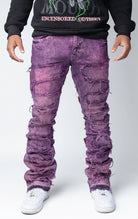 Blush distressed and stacked flare jeans featuring an ombre wash and ripped details