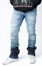 Blue distressed and stacked flare jeans featuring an ombre wash and ripped details
