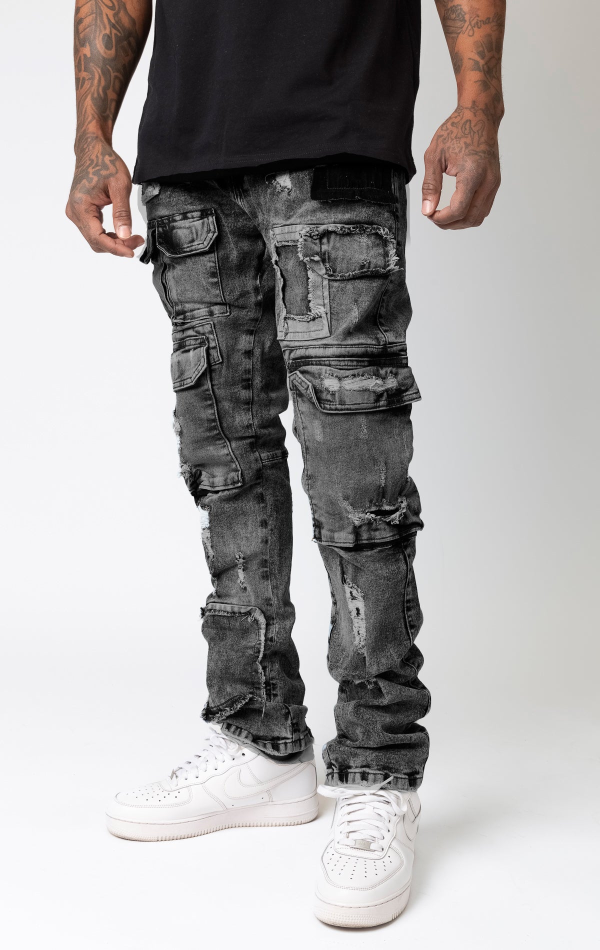 Slim fit cargo denim jeans featuring black washout repair details.