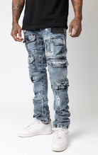 Slim fit cargo denim jeans featuring blue washout repair details.