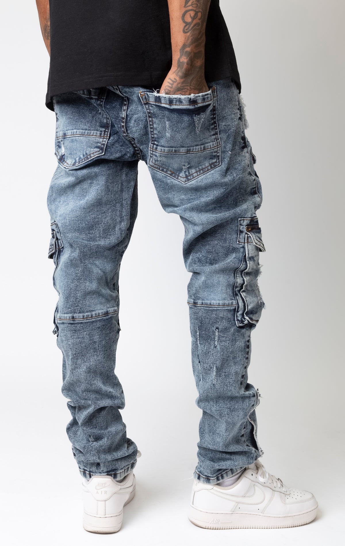 Slim fit cargo denim jeans featuring blue washout repair details.