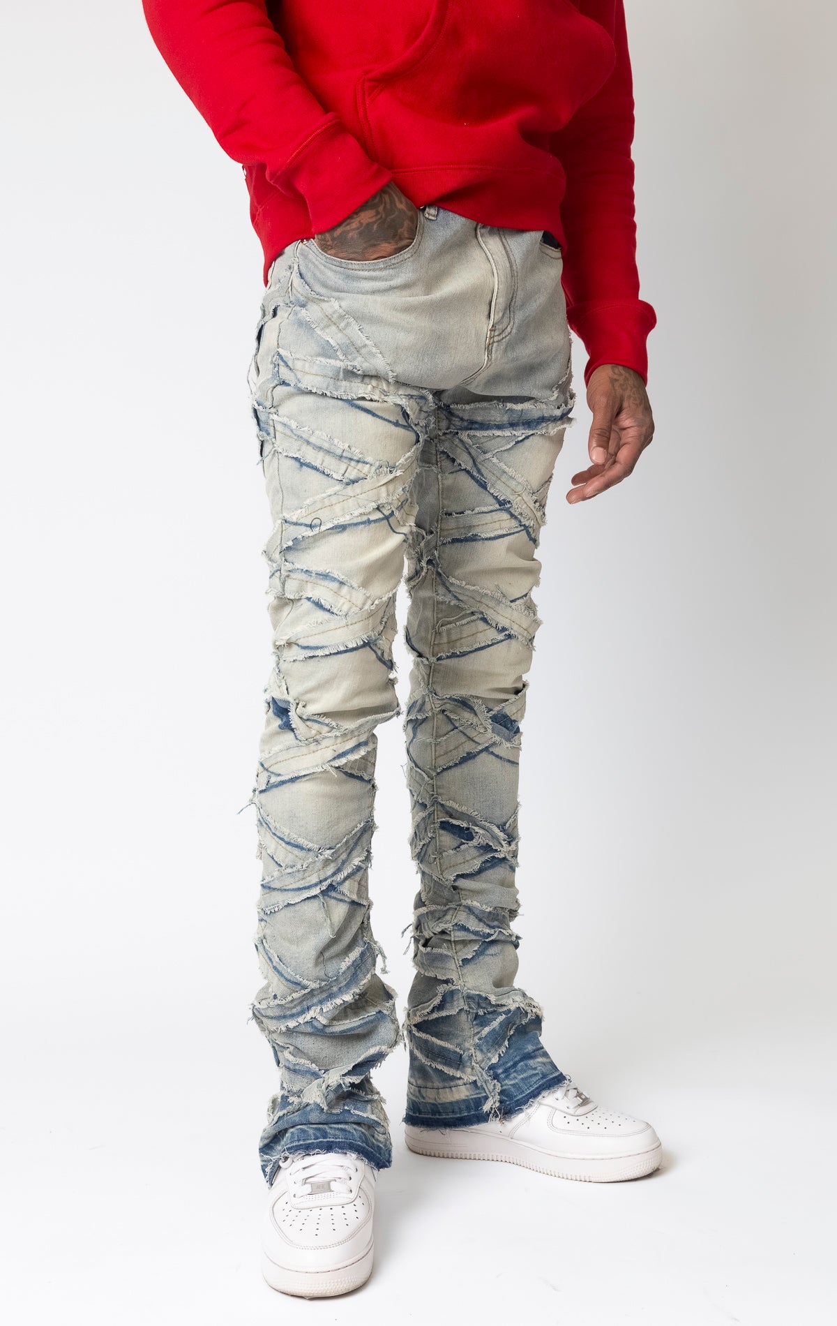 Antique bleach Distressed stacked jeans with a cut and sew panel construction, frayed detailing, and stretch fabric.