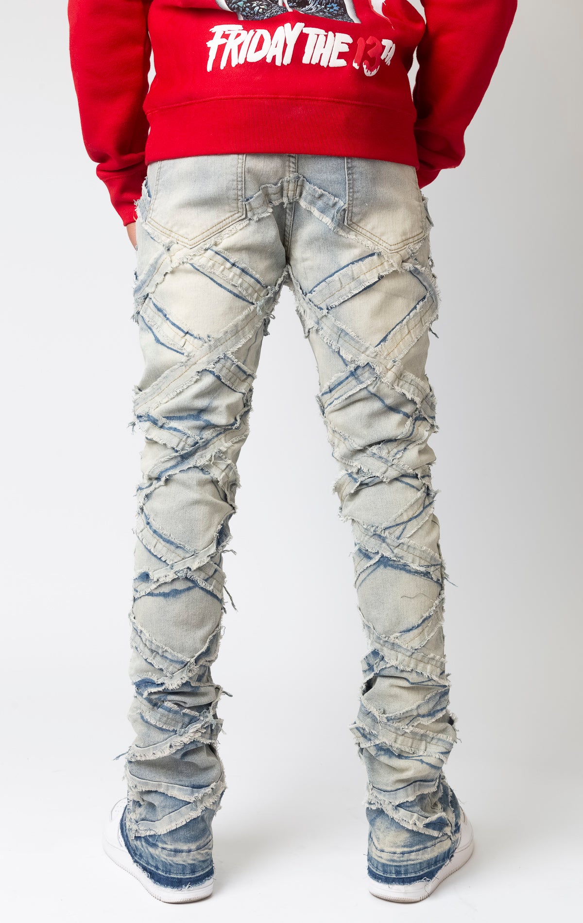 Antique bleach Distressed stacked jeans with a cut and sew panel construction, frayed detailing, and stretch fabric.