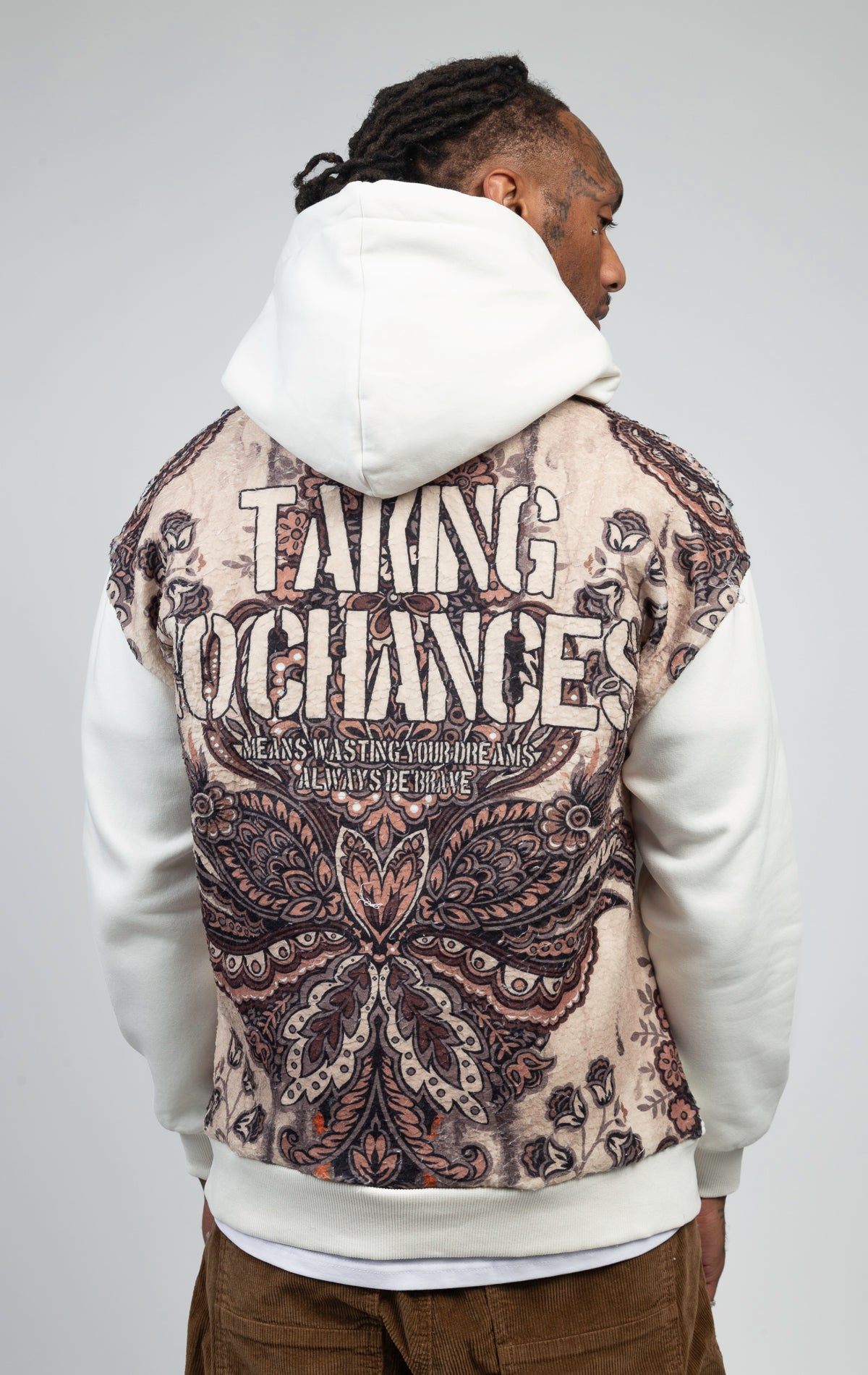 A soft and breathable oversized hoodie featuring vibrant and unique printed "TAKING NO CHANCES" designs on the back.