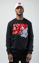Black stylish and comfortable sweatshirt featuring a vibrant lucky charm bunny print and an empowering 'Young, Rich, and Lucky' slogan.