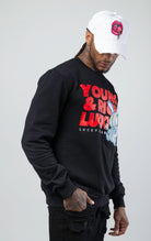Black stylish and comfortable sweatshirt featuring a vibrant lucky charm bunny print and an empowering 'Young, Rich, and Lucky' slogan.