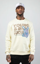 Off white stylish and comfortable sweatshirt featuring a vibrant lucky charm bunny print and an empowering 'Young, Rich, and Lucky' slogan.