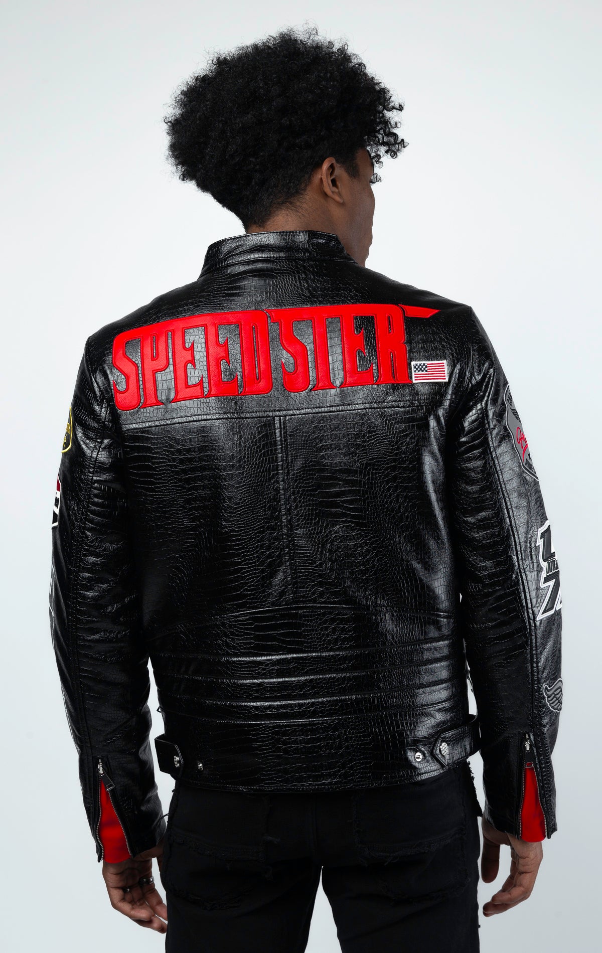 Black Leather motorcycle jacket featuring a bold "Speedster" graphic on the back. This varsity style jacket includes ribbed cuffs and collar, and a sleek silver zipper closure