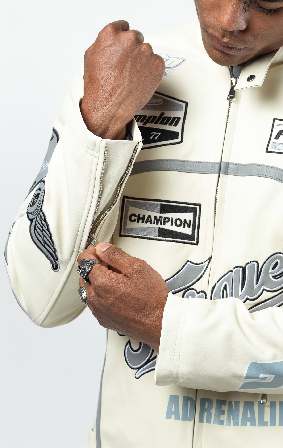 Cream Leather motorcycle jacket featuring a bold "Speedster" graphic on the back. This varsity style jacket includes ribbed cuffs and collar, and a sleek silver zipper closure