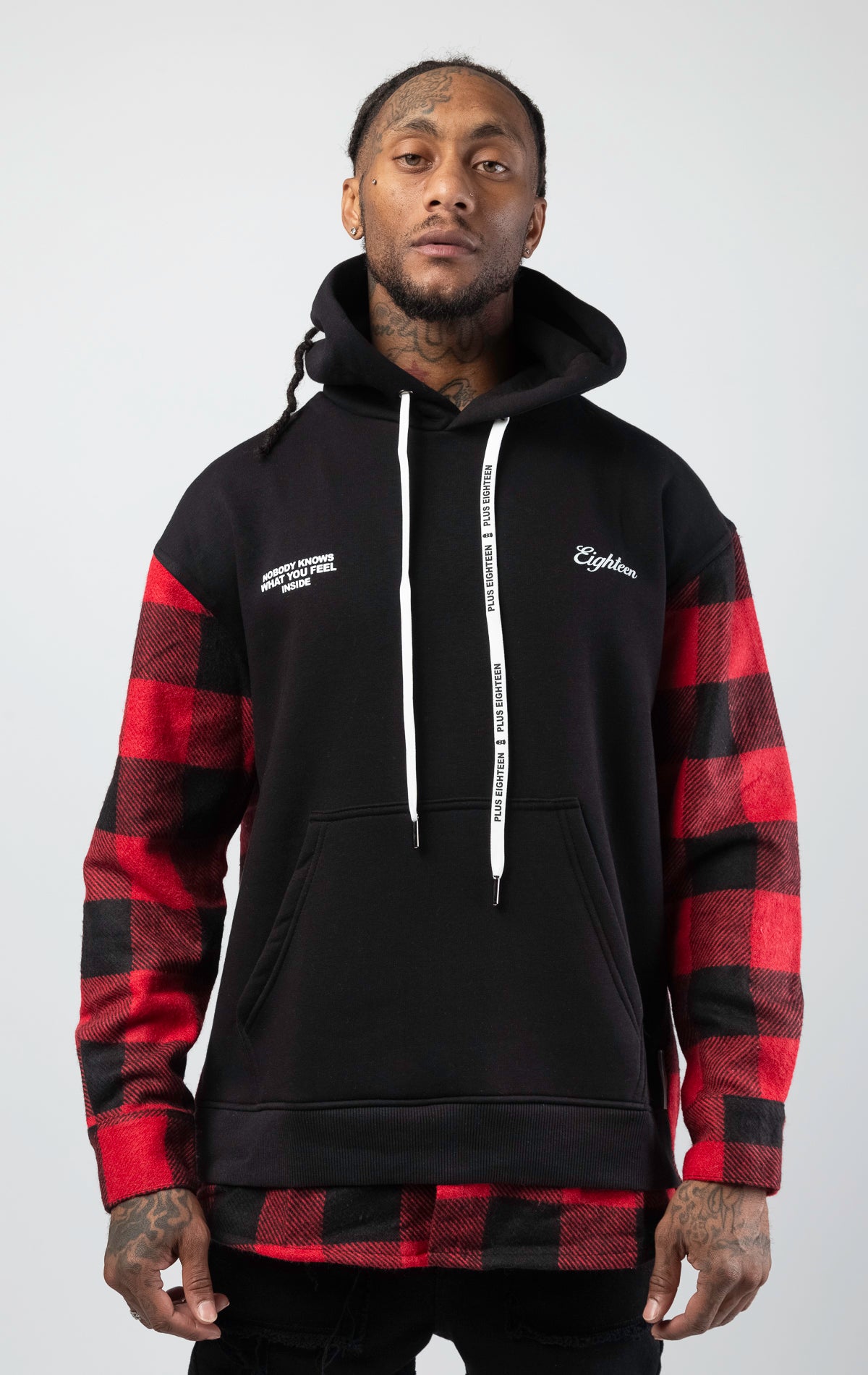 Pullover hooded sweatshirt with plaid pattern on back and sleeves.