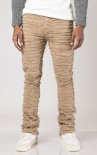 Khaki Men's mid-rise, non-stretch jeans in a dark wash with an extreme frayed logo design on the inseam. The jeans feature a stacked leg design, five pockets, belt loops, and a zipper fly with a top button closure. Made from 100% cotton.  