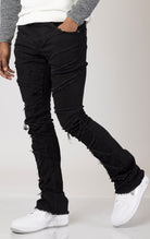 Men's mid-rise, stretchy jeans in a dark wash with a stacked leg design. The jeans feature a purple lace screen print throughout the legs, five pockets, belt loops, and a zipper fly with a top button closure.