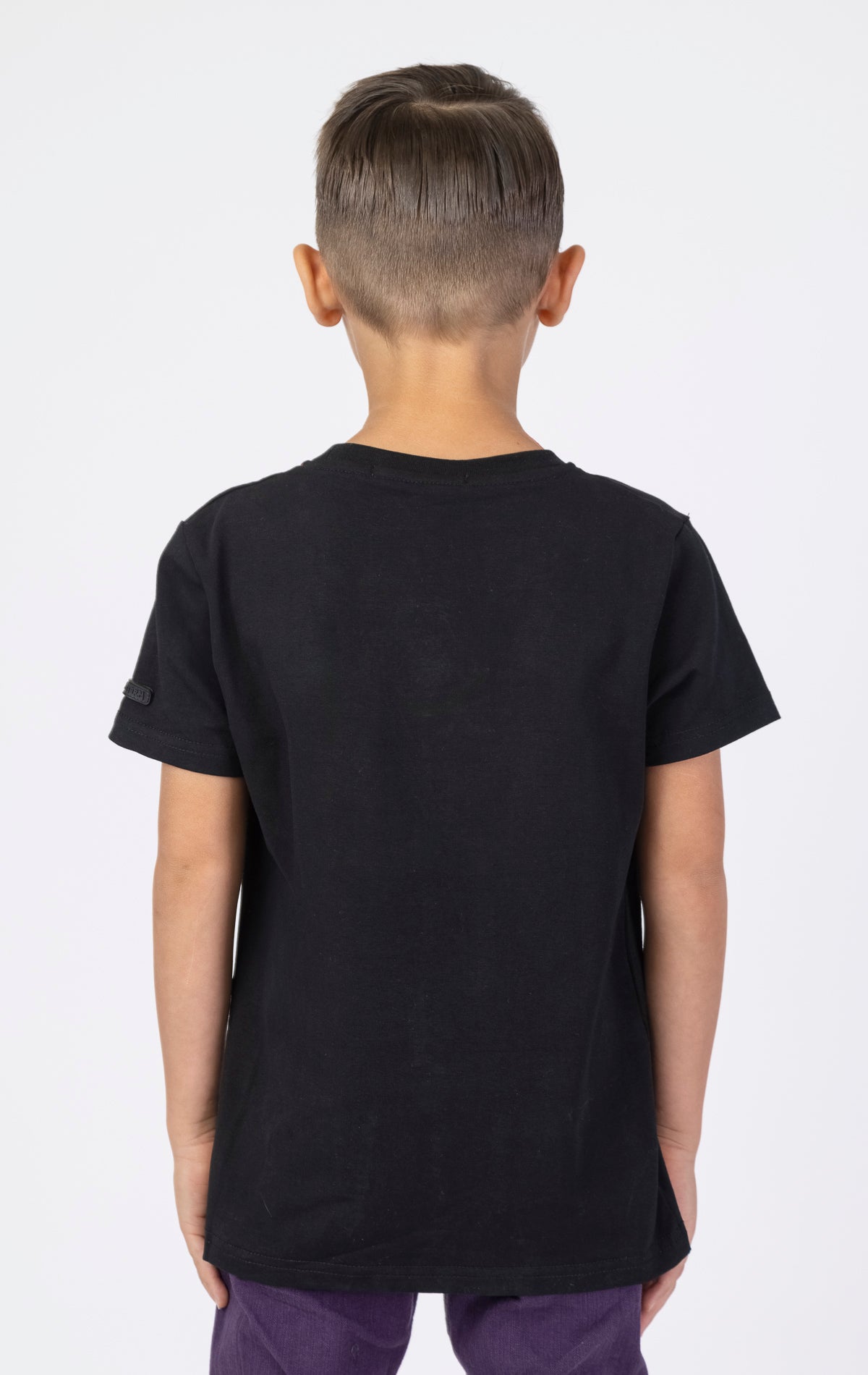 Black Keys Kids Lucky Charm Tee with a black reflective patch. Made from a soft blend of 95% cotton and 5% spandex. Features a crewneck style and a playful lucky charm graphic