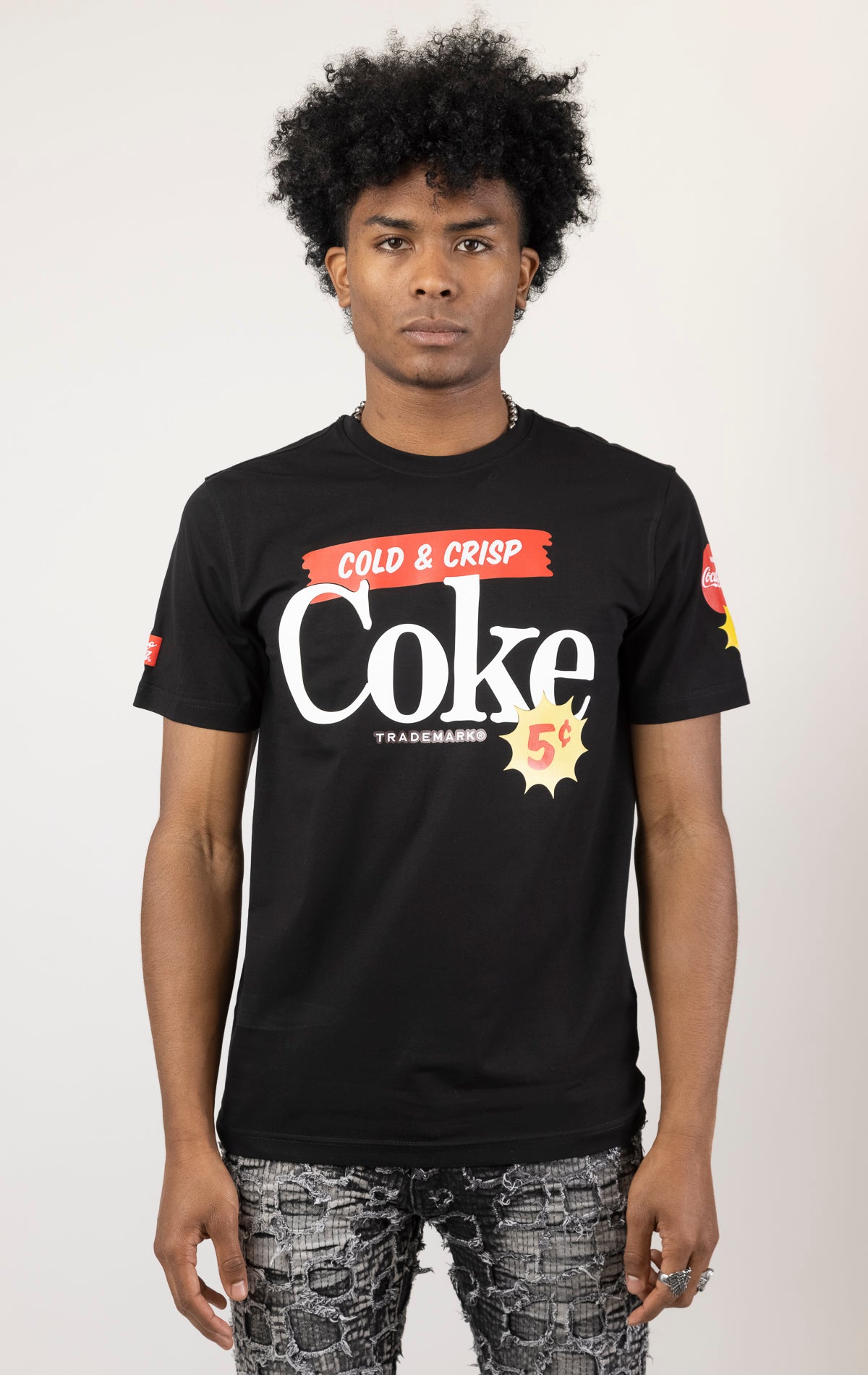 Men's black short-sleeve t-shirt in a classic fit. The shirt features Coca-Cola logos and images screen-printed on both the front and the back. 