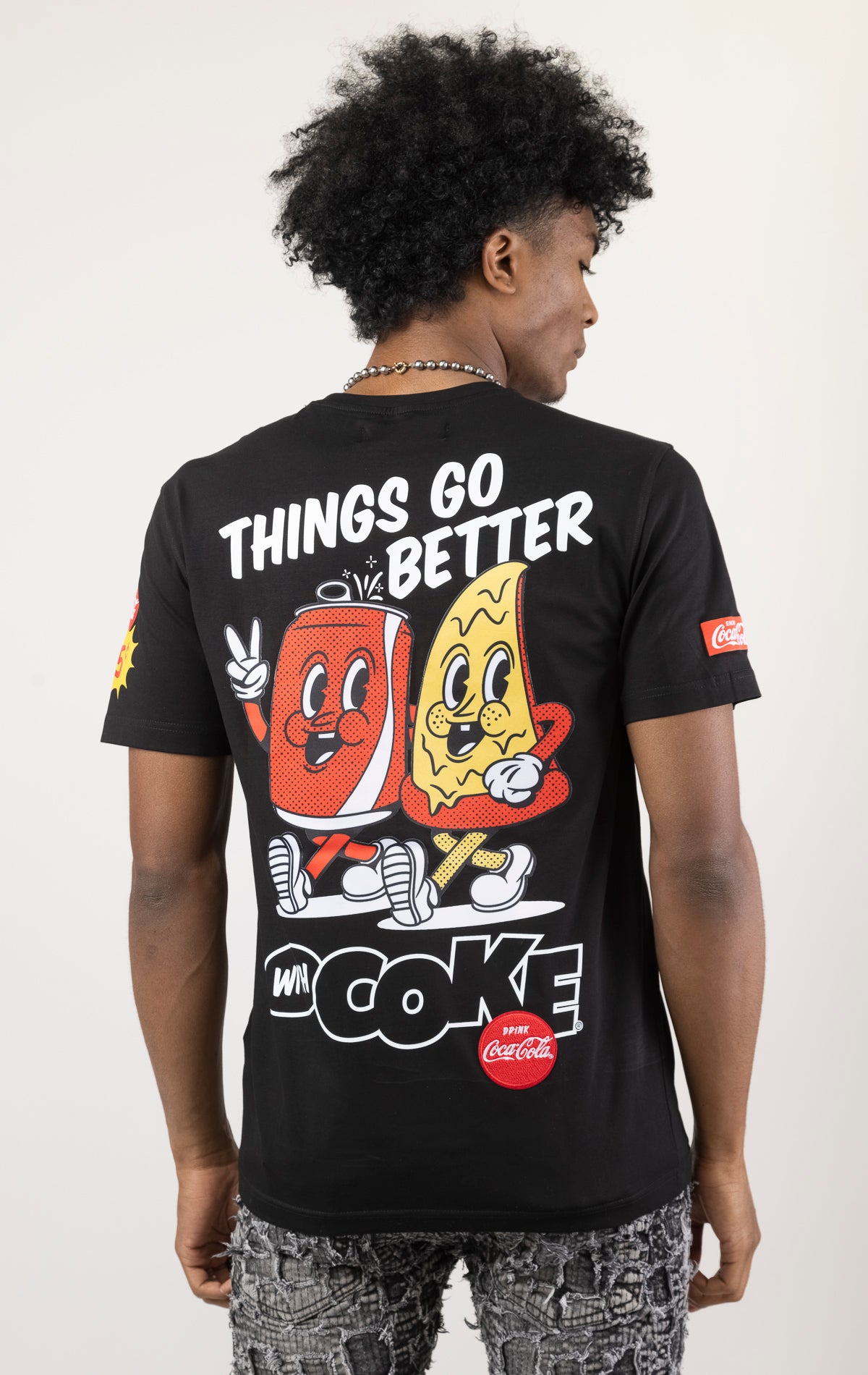 Men's black short-sleeve t-shirt in a classic fit. The shirt features Coca-Cola logos and images screen-printed on both the front and the back.