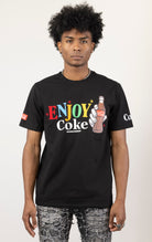 Men's black short-sleeve crew neck t-shirt in a variety of colors. The shirt features a Coca-Cola logo graphic on the front. The graphic is heat-sealed and the tee is made from a blend of 94% cotton and 6% spandex.