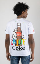 Men's white short-sleeve crew neck t-shirt in a variety of colors. The shirt features a Coca-Cola logo graphic on the front. The graphic is heat-sealed and the tee is made from a blend of 94% cotton and 6% spandex.