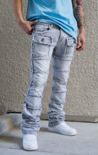 Stacked denim pants, distressed and paneled with a raw finishing