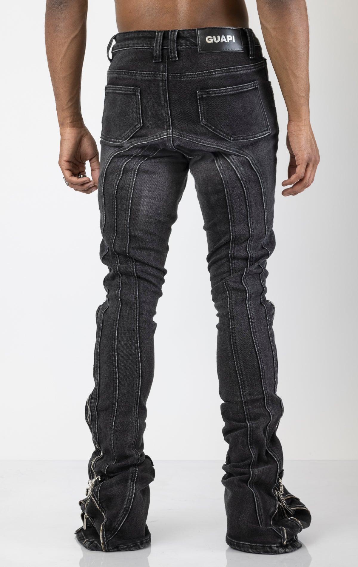 Men's black jeans with a unique stacked iron chain hardware embellishments at the ankle. The jeans have a skinny fit (size up for a more relaxed fit)
