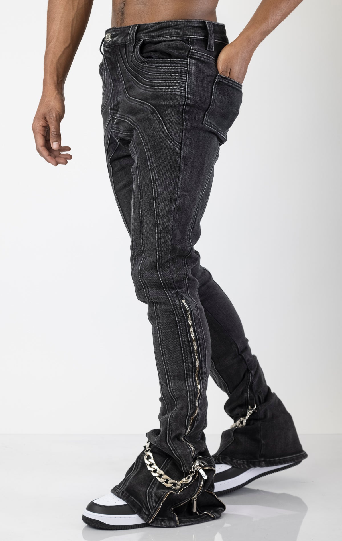 Men's black jeans with a unique stacked iron chain hardware embellishments at the ankle. The jeans have a skinny fit (size up for a more relaxed fit)