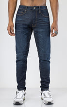 Men's Sean Slim Taper jeans in dark indigo. The jeans feature a regular rise waist, a comfortable fit from waist to thigh, a slim taper from knee to ankle, 3D baked wrinkles for texture, a raw denim look, and are made from a super stretch fabric blend (35