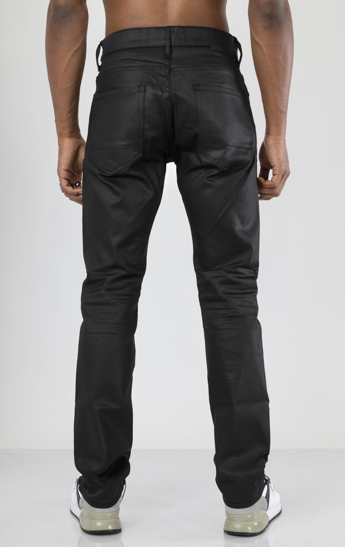 Men's black denim pants with a glossy coated finish. The pants feature a regular rise, straight leg fit, 3D hand-formed wrinkles for texture, and are made from a super stretch fabric blend (67% Modal, 29% Polyester and 4% Elastane).