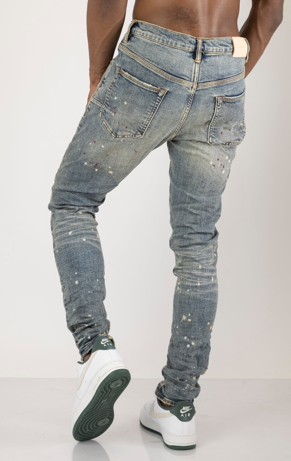 Vintage Spotted Indigo Jeans in dark wash with subtle lighter colored spots. Made from 98% cotton and 2% elastane for comfort. Features include lined back pockets and yoke for comfort and shape retention, reinforced belt loops, and hidden back pocket rive