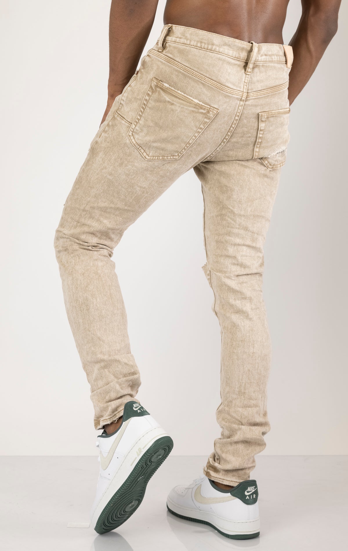 Beige Skinny Jeans with a contrasting plaid patch. Made from 98% cotton and 2% lycra. Features include a signature purple hangtag, lined back pockets and yoke for comfort and shape retention, reinforced belt loops, hidden back pocket rivets, and a classic