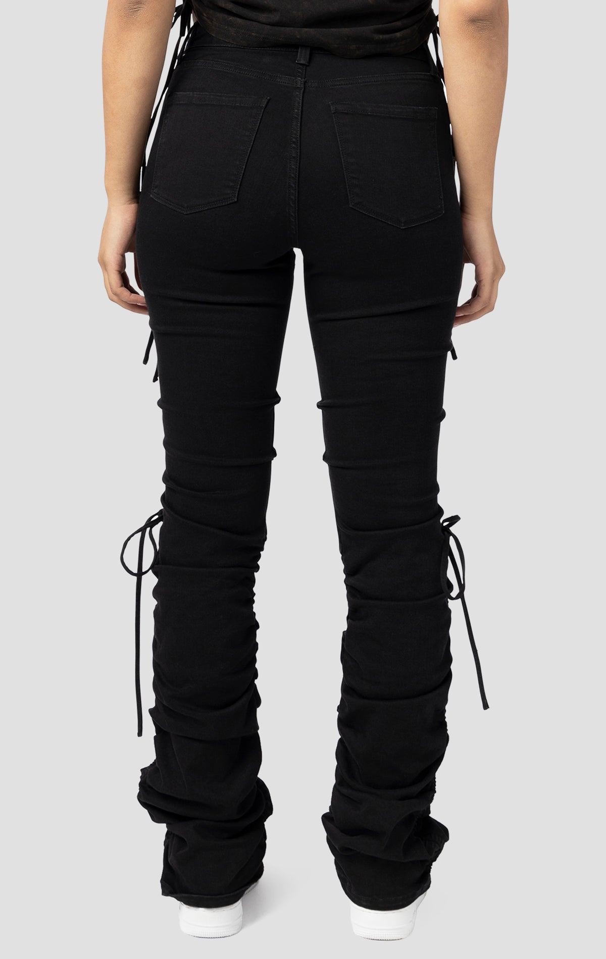 Black High rise strap bootcut twill pants.