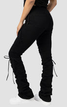 Black High rise strap bootcut twill pants.