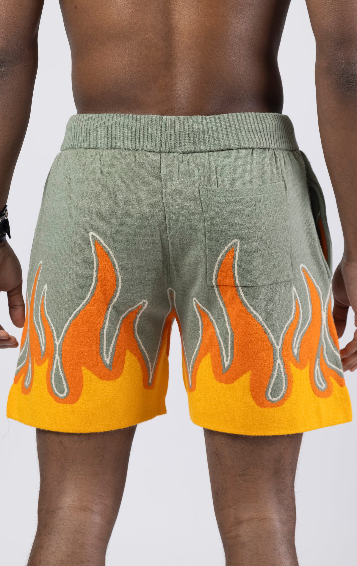 Sprayground Flame Sweater Shorts in sage green. Made from a soft and comfortable sweater material, these shorts feature a bold flame design on the bottom.